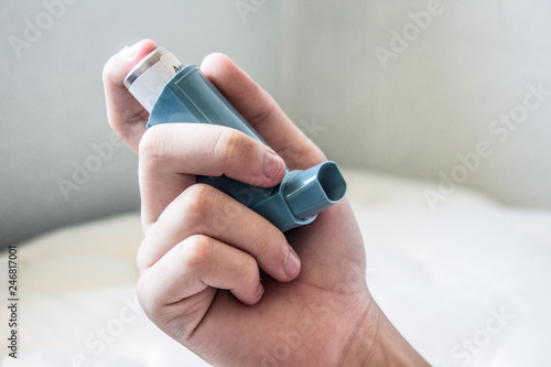 hand holding asthma medicine photo