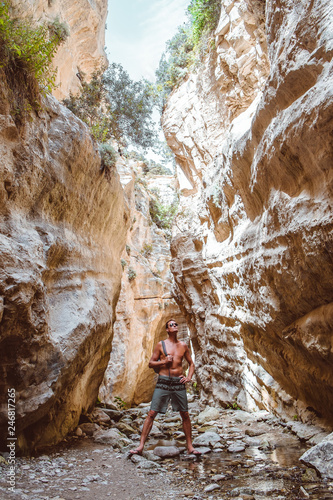 Young caucasian tourist in beautiful Avakas Gorge valley during trekking. Landscape taken on Cyprus island.