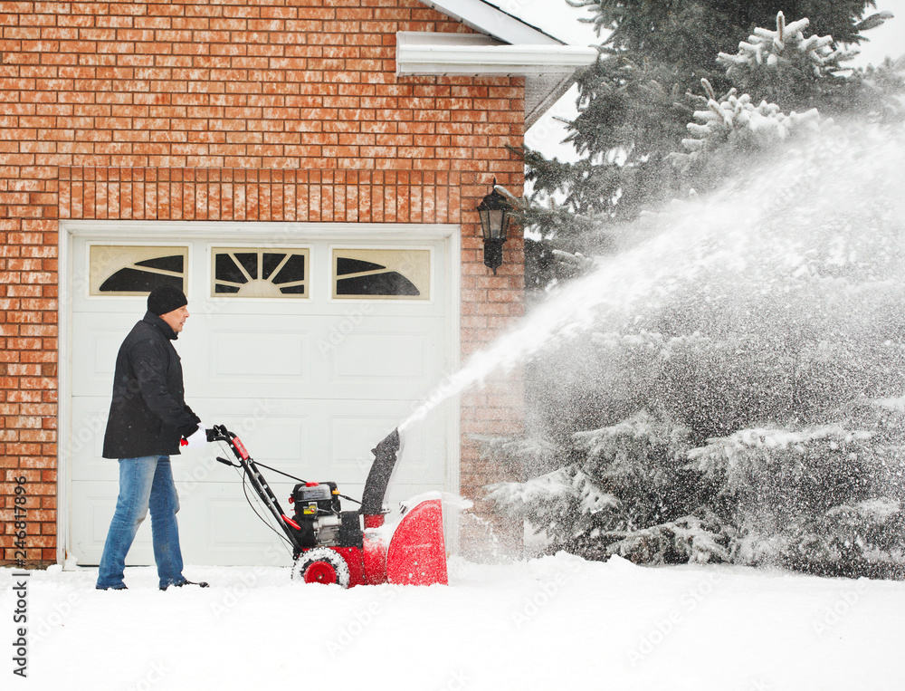Obraz premium Man using a snow blowing machine, Canada