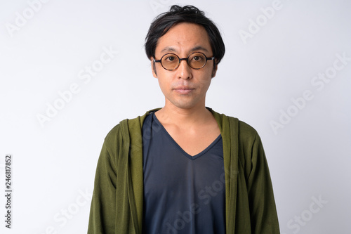 Portrait of Japanese man with eyeglasses against white background