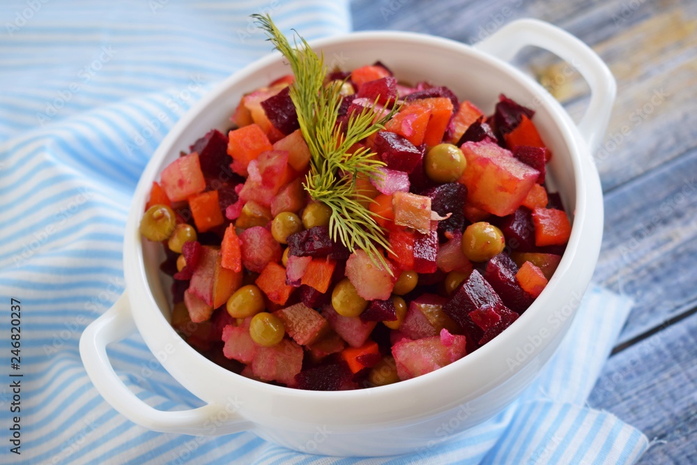 Vegetable salad with carrots and beets.Vinaigrette on a white plate.Vegetarian food. Vegetable salad with carrots and beets.Vinaigrette on a white plate.Vegetarian food.