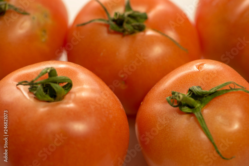 Red tomatoes on a background of a white color