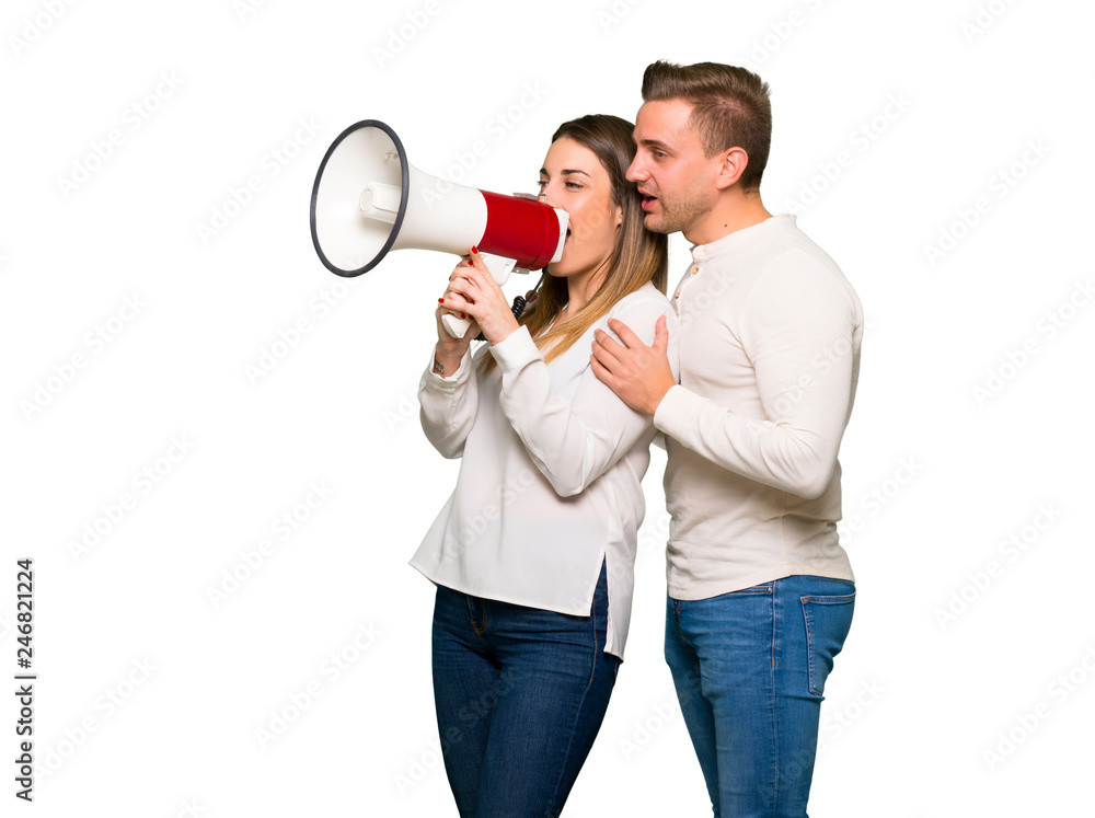 Couple in valentine day shouting through a megaphone Couple in valentine day shouting through a megaphone