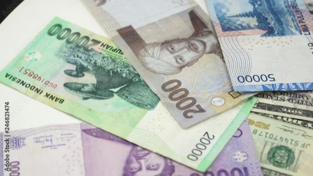 Indonesia money and US dollar on white background. 4K Indonesia money and US dollar on white background. 4K