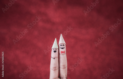 Finger with emotion on red background © Johnstocker