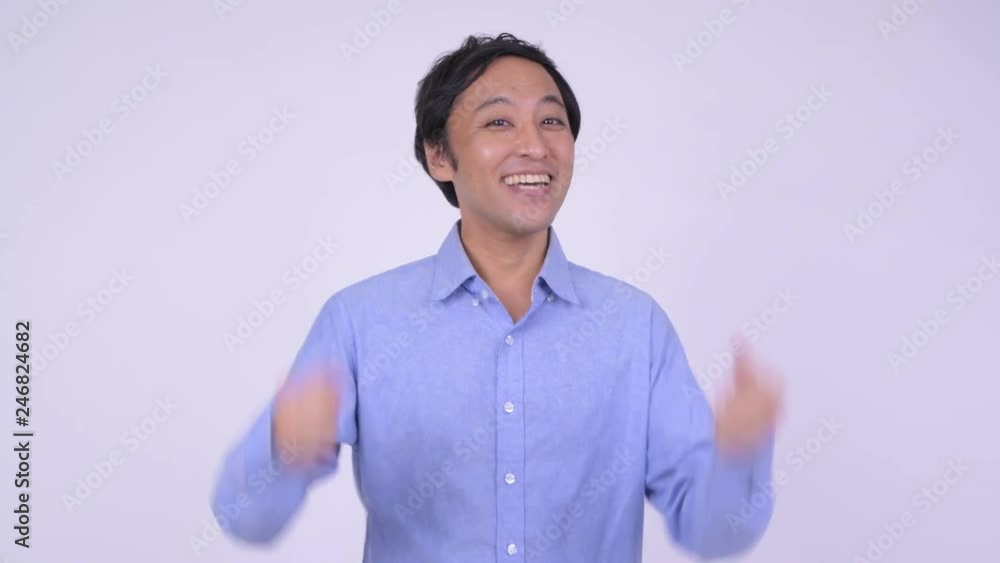 Happy Japanese businessman smiling and giving thumbs up Happy Japanese businessman smiling and giving thumbs up