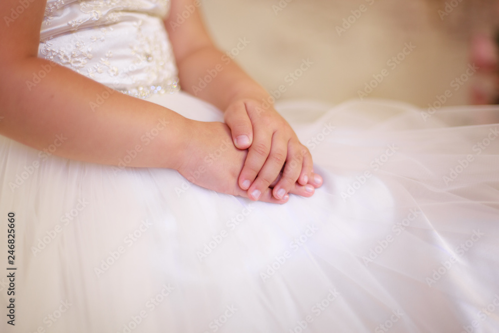 tender baby hands, girl in dress, tulle, closeup tender baby hands, girl in dress, tulle, closeup