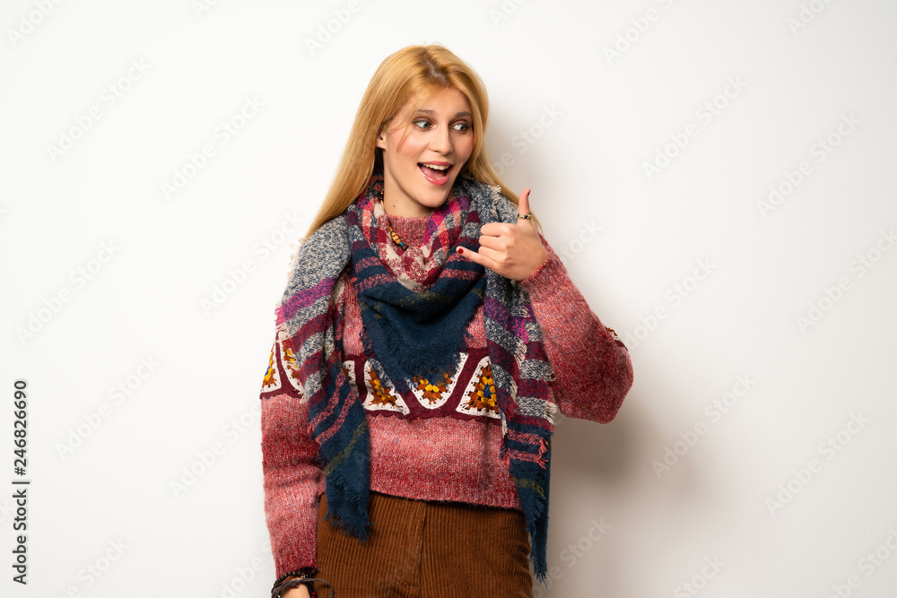 Hippie woman over white wall making phone gesture. Call me back sign Hippie woman over white wall making phone gesture. Call me back sign