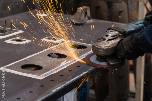 Surface grinding on steel workpiece photo