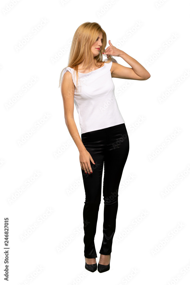 Young blonde woman making phone gesture and doubting over isolated white background Young blonde woman making phone gesture and doubting over isolated white background