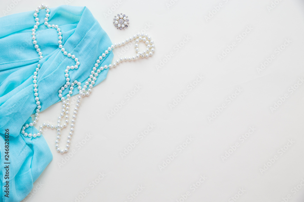 Fototapeta premium Top view Blue fabric fashion and pearl