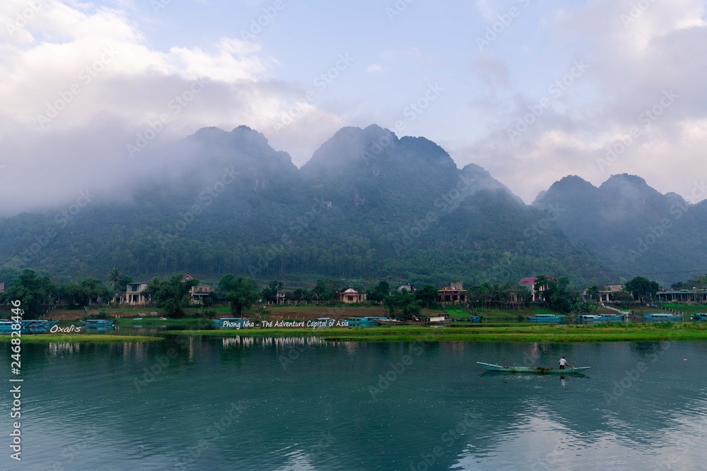 custom made wallpaper toronto digitalCalm river with boats in the National Park of Phong Nha Ke Bang, Vietnam. Beautiful sunrise with hanging clouds in the hills.