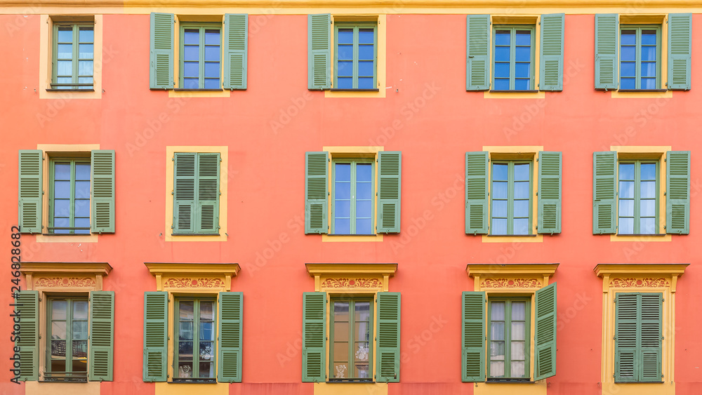Nice, colorful facade, with typical windows and green shutters
