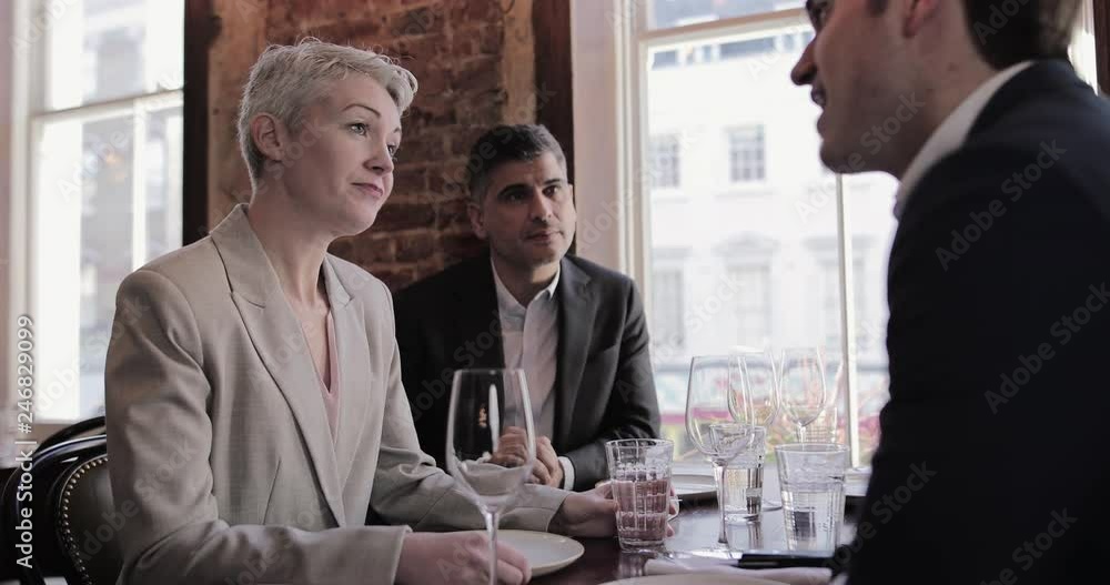 Business executives having a working lunch in a restaurant Business executives having a working lunch in a restaurant