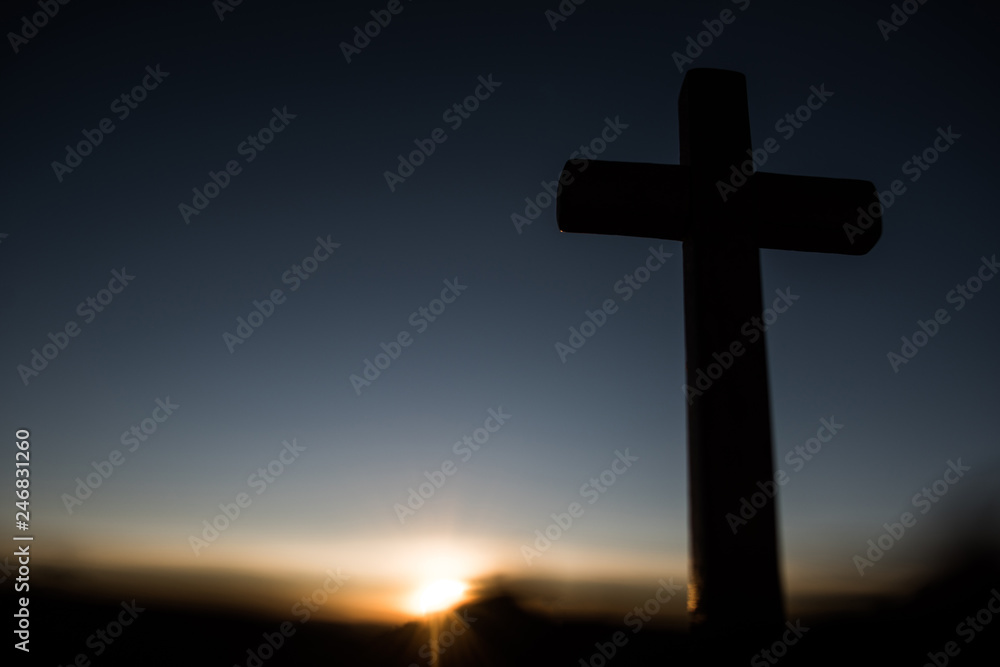 Silhouette of catholic cross and sunrise Silhouette of catholic cross and sunrise