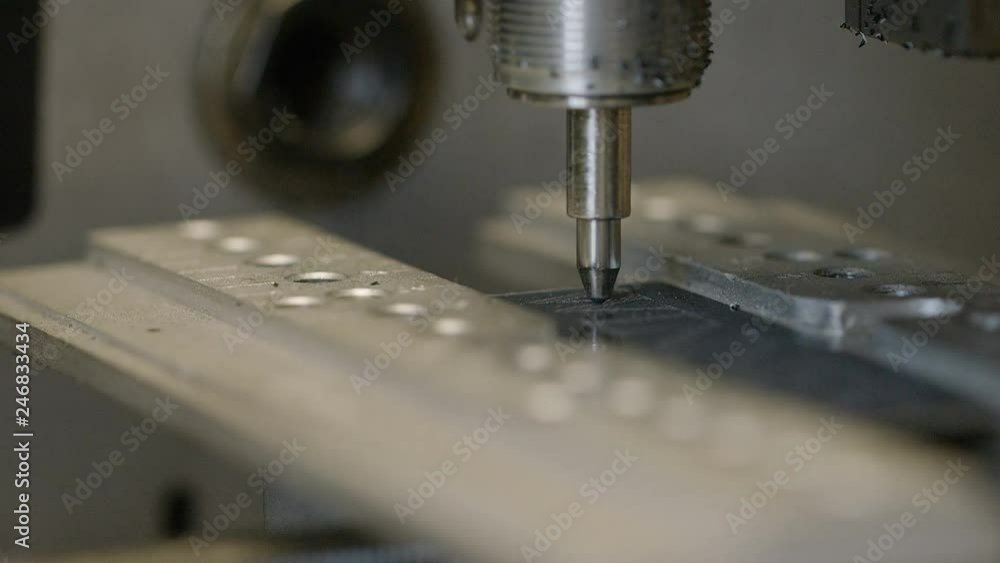 Close up of CNC diamond blade engraver etching text onto a surface Close up of CNC diamond blade engraver etching text onto a surface