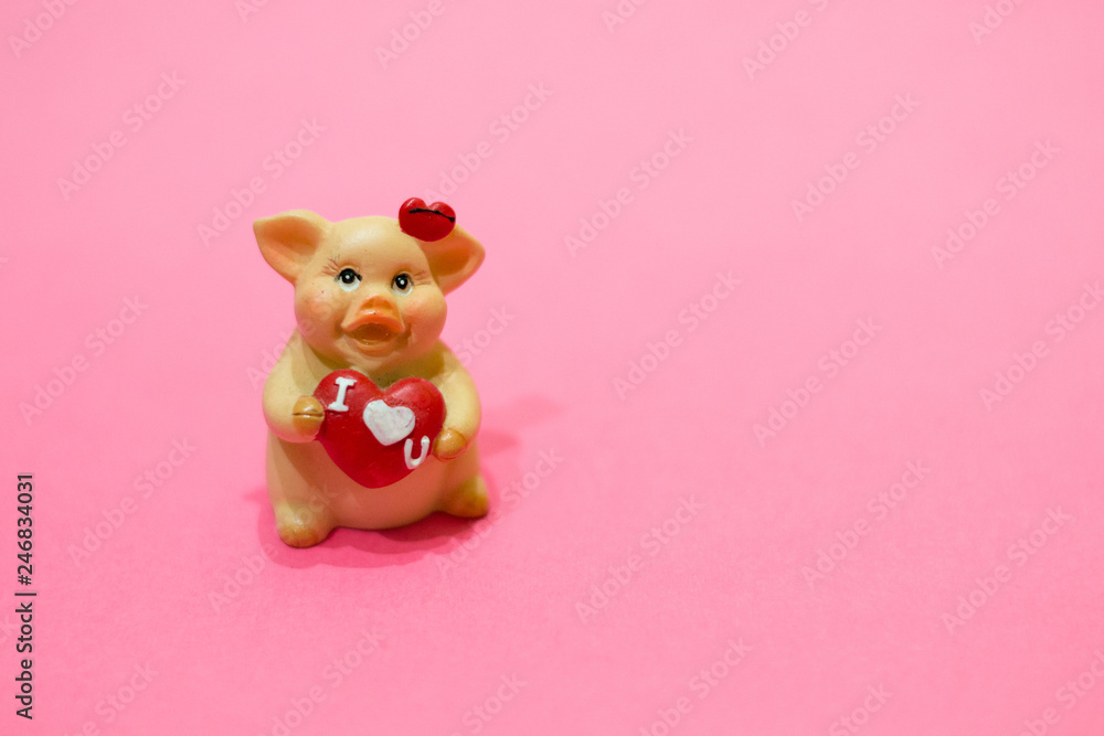 Figurine of lovely ceramic pig with heart on pink background. Concept of love, Valentine's day, China New 2019 Year, feelings, greetings. Figurine of lovely ceramic pig with heart on pink background. Concept of love, Valentine's day, China New 2019 Year, feelings, greetings.