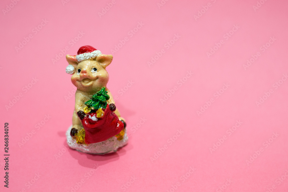 Christmas tree decoration in shape of pig with fir tree and Santa costume on living coral background. Happy China New 2019 year, copy space, symbol.