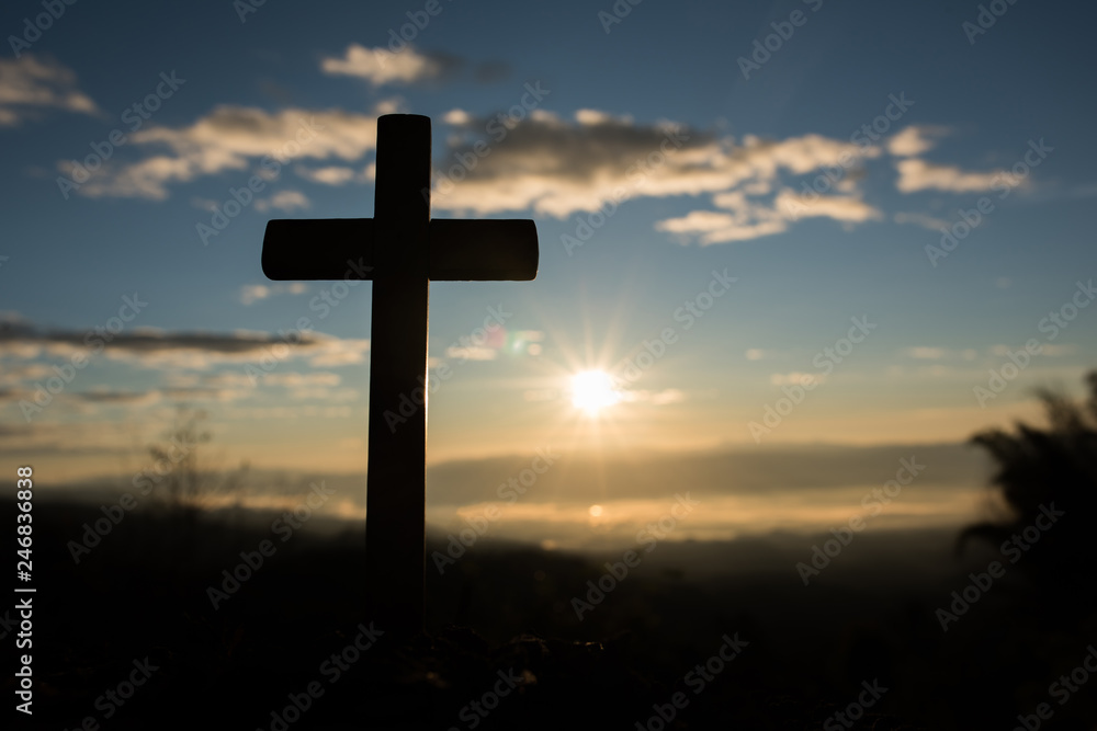 Silhouette of catholic cross and sunrise Silhouette of catholic cross and sunrise
