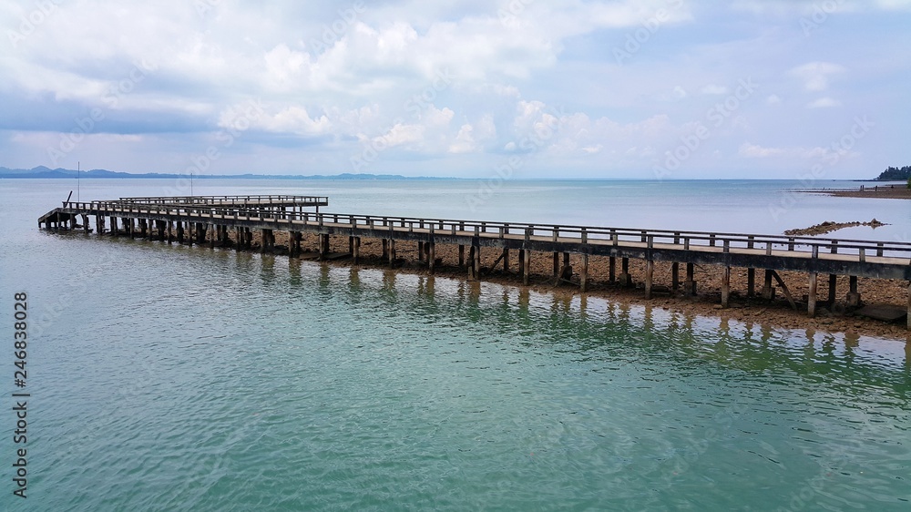 long wooden pier going far into the sea