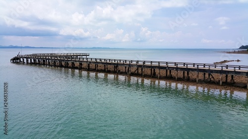 long wooden pier going far into the sea