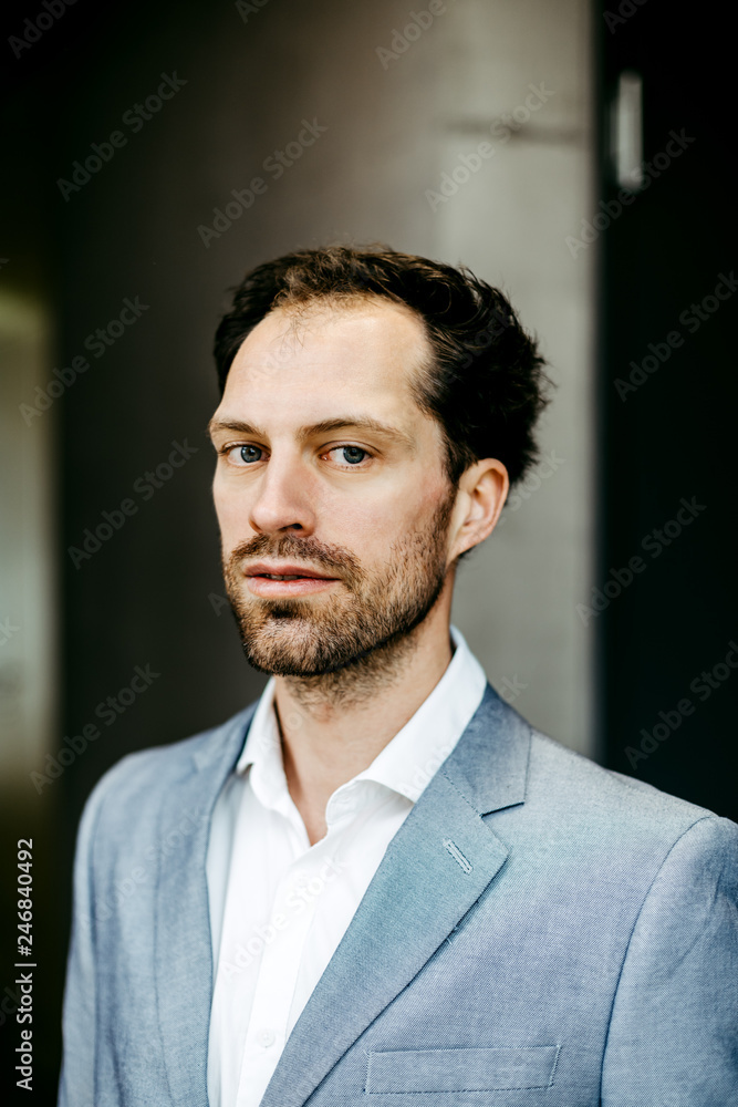 serious businessman in suit looking into camera serious businessman in suit looking into camera