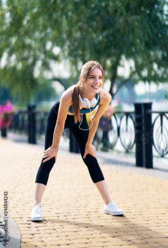Woman in fit wear tired, during morning jogging