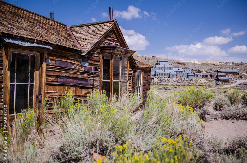 Buildings in the abandoned ghost town of Bodie California. Bodie was a busy, high elevation gold mining town in the Sierra Nevada Mountains in the early 1900s Buildings in the abandoned ghost town of Bodie California. Bodie was a busy, high elevation gold mining town in the Sierra Nevada Mountains in the early 1900s