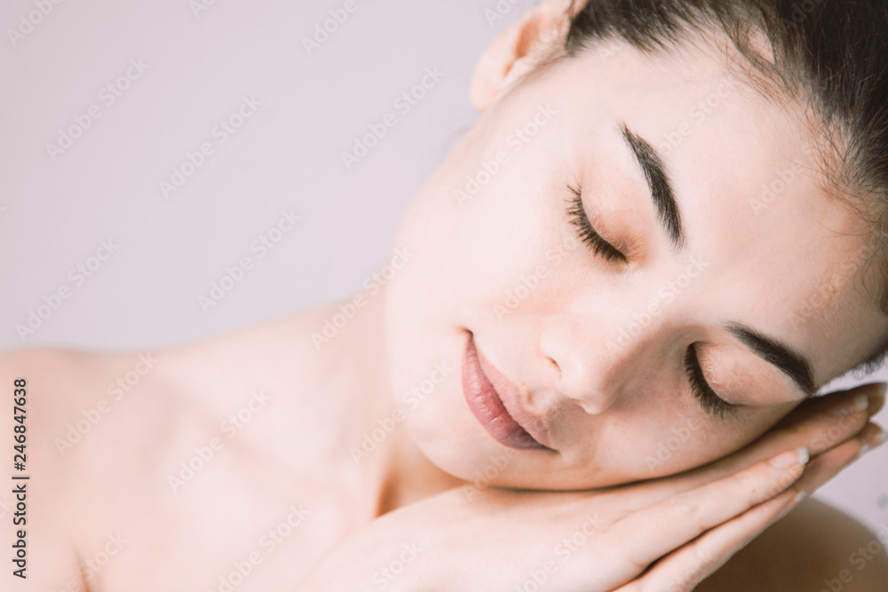 Healthy skin woman beautiful face close up over gray background Healthy skin woman beautiful face close up over gray background