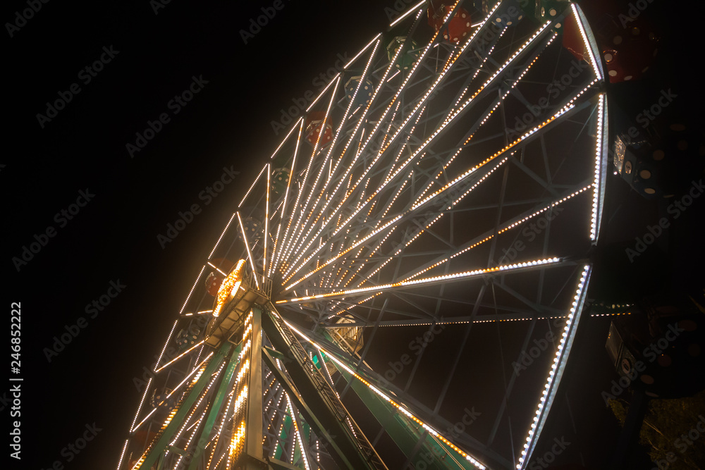 Fototapeta premium Ferris wheel at the amusement park, night illumination