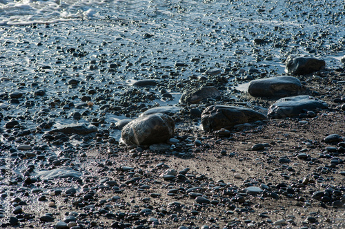 rock seaside shore with black stone on the island