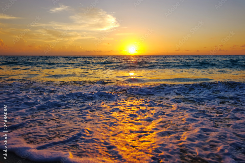Beach view at sunrise where sea water meets sky on vacation.  Landscape views for relaxing serenity and peace.