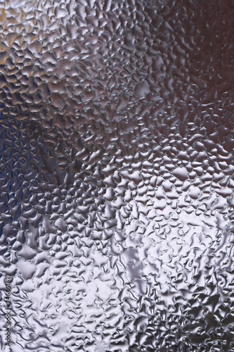 Water drops on glass window close up with blurred background. Drops in macro. Condensate on window closeup. Wet air.