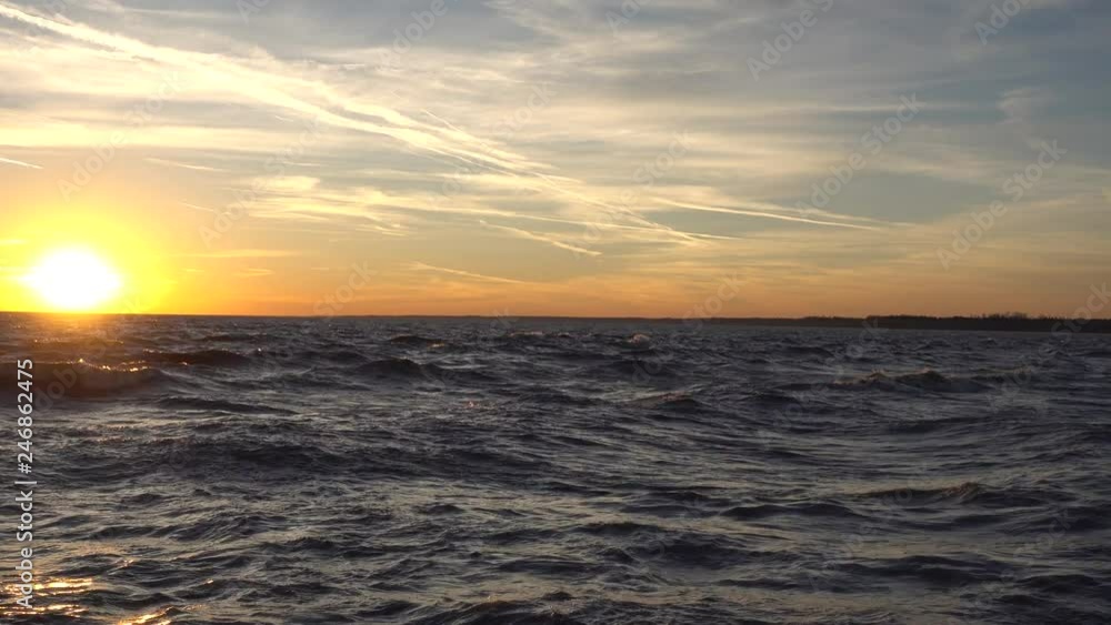 4K Orange Golden Sunset On Ocean Water And Waves With Land In Distance 4K Orange Golden Sunset On Ocean Water And Waves With Land In Distance