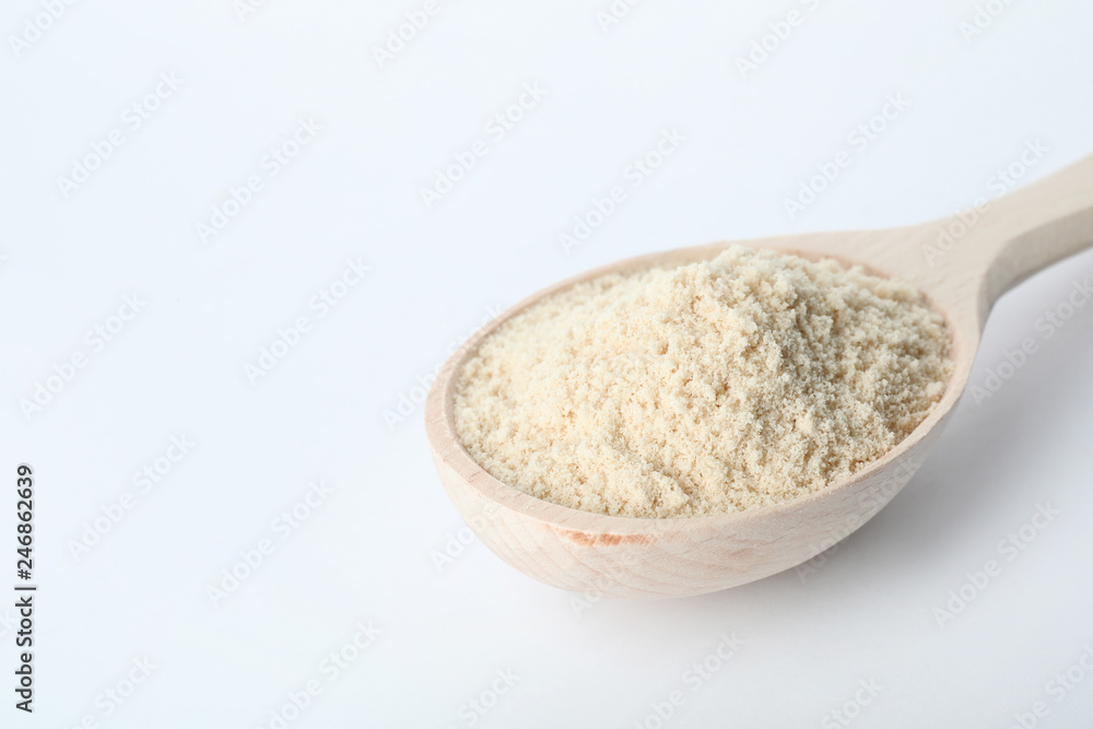 Spoon of sesame flour isolated on white. Space for text Spoon of sesame flour isolated on white. Space for text