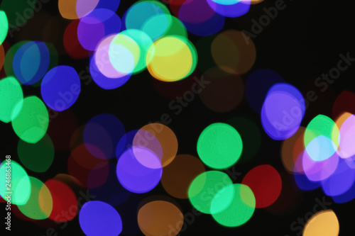 Beautiful colorful lights on dark background. Bokeh effect