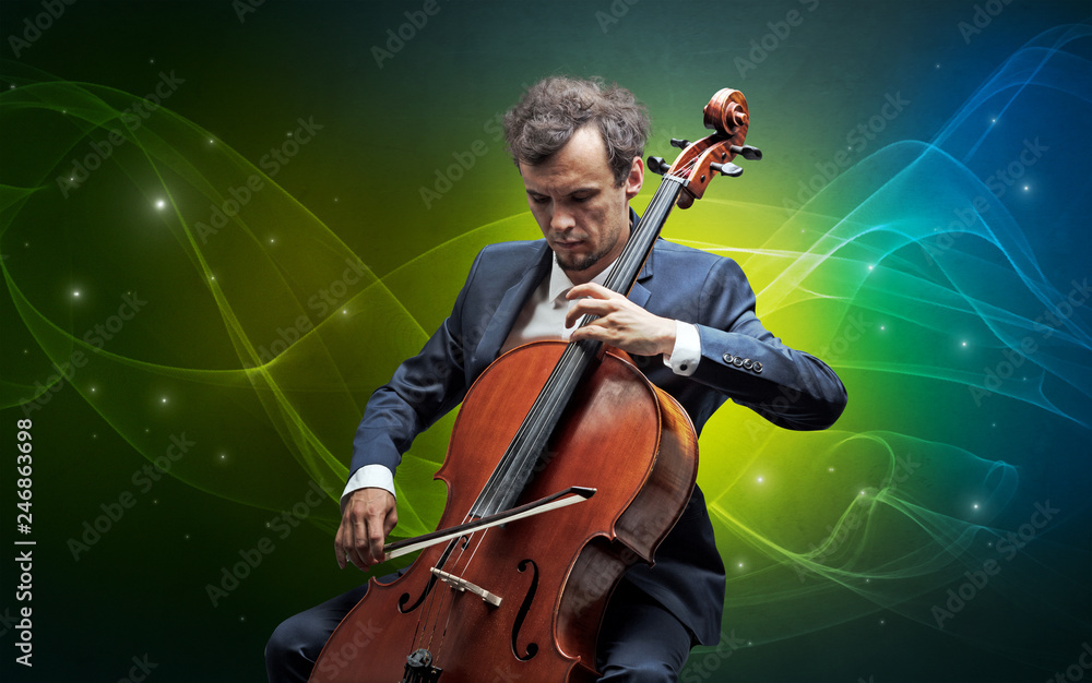 Fototapeta premium Serious classical cellist with fabled sparkling wallpaper