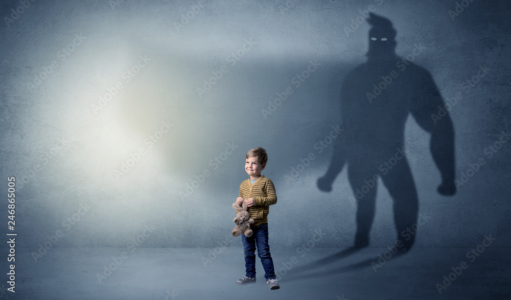 Cute kid in a room with plush on his hand and hero shadow on his background
Cute kid in a room with plush on his hand and hero shadow on his background