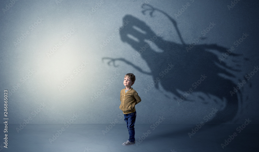 Scary ghost shadow in a dark empty room with a cute blond child
 - obrazy, fototapety, plakaty 