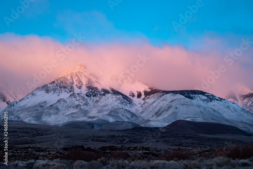 colorful cloudy morning sunrise sky over snowy mountain peaks of Sierra nevadas  California