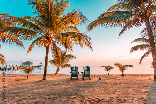 Two empty chairs at a beach sunset photo