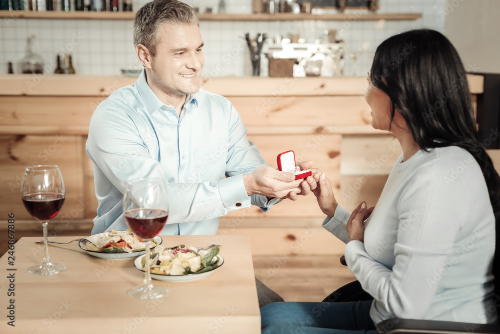 Surprised woman accepting engagement ring from man Surprised woman accepting engagement ring from man