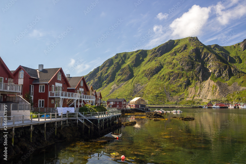 Obraz premium colorful houses and harbor at the foot of the mountains in Lofoten