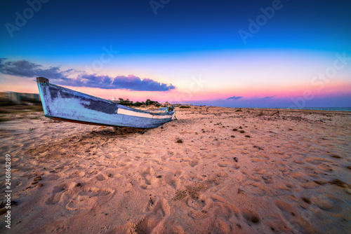 Fishing boat on the evening beach. Hammamet, Tunis.