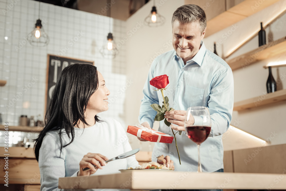 Smiling man bringing flower and candies Smiling man bringing flower and candies