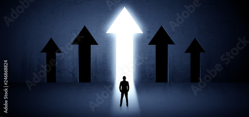 Young businessman with back choosing the best way
