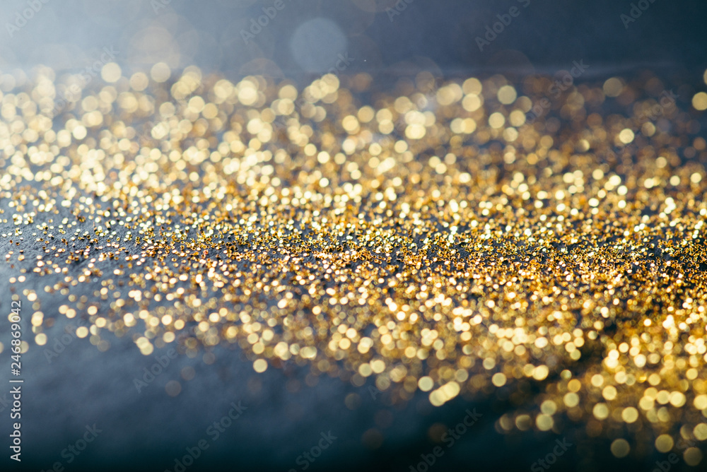 gold confetti on black background - obrazy, fototapety, plakaty 