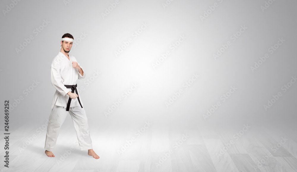 Young kung-fu trainer fighting in an empty space
Young kung-fu trainer fighting in an empty space