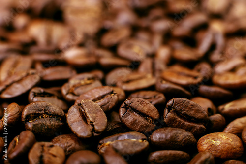 Aroma roasted coffee beans, brown background. Soft focus close up.