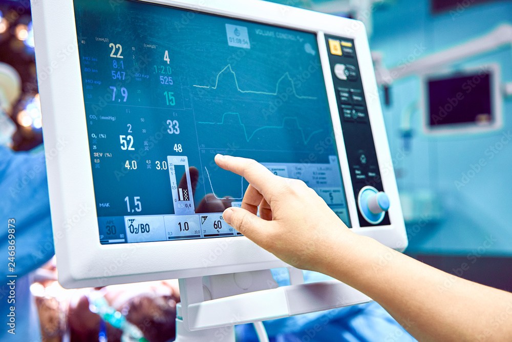 Monitoring patient's vital sign in operating room. doctor cheking at patient's vital signs. Cardiogram monitor during surgery in operation room. Monitoring patient's vital sign in operating room. doctor cheking at patient's vital signs. Cardiogram monitor during surgery in operation room.